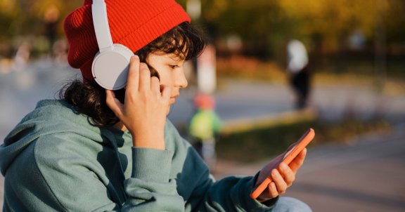 childs first phone, teen on phone, what age to get a phone