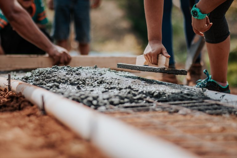 group of people laying concrete foundation