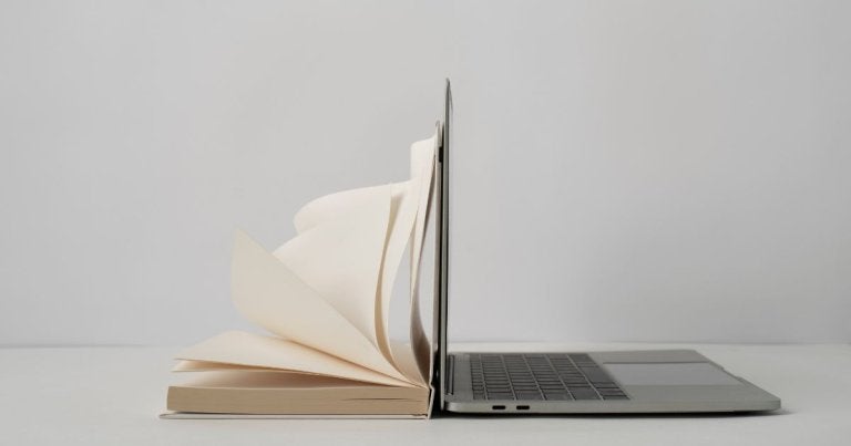 internet archive, wayback machine, image of book laying on laptop